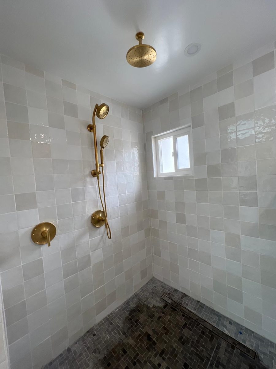 Zellige tile shower with brushed brass fixtures