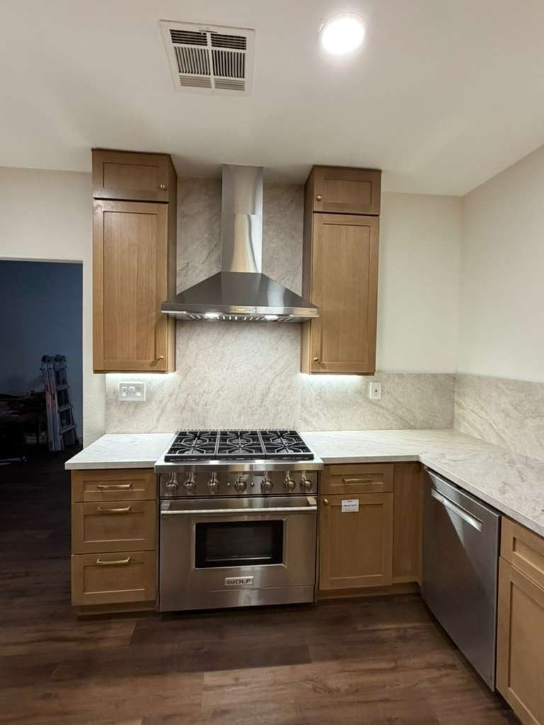 Kitchen remodel with pro range and quartz backsplash