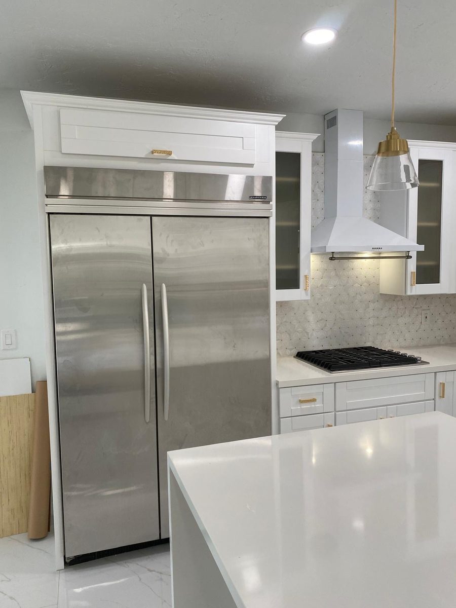 White kitchen with panel and built-in fridge
