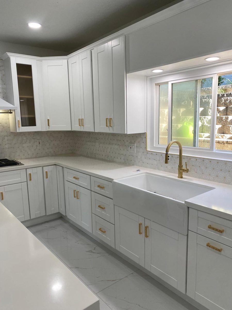 White kitchen with farmhouse sink and gold fixtures